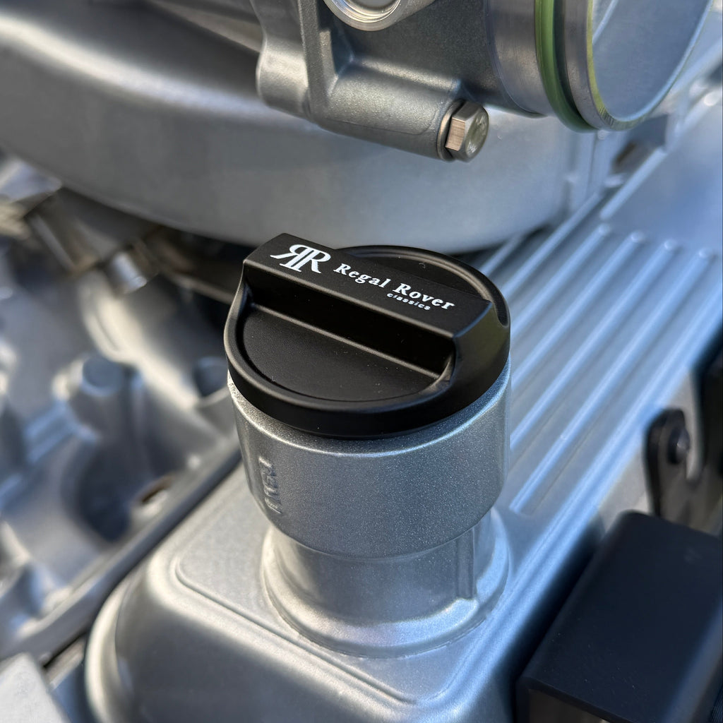 Close-up of a mechanical component with a brand logo on a vehicle engine.