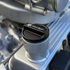 Close-up of a mechanical component with a brand logo on a vehicle engine.